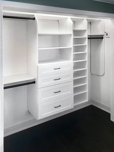 an empty white closet with drawers and shelves