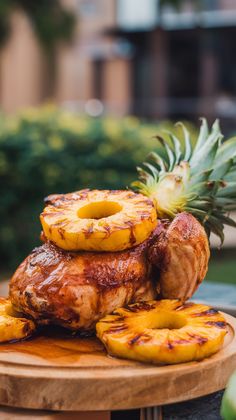 pineapples are stacked on top of grilled meat