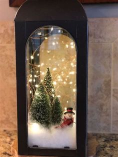 a snow globe with christmas trees in it