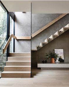 the stairs in this modern house are made of wood and glass, with no railings or handrails