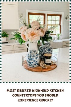 a kitchen counter top with vases and flowers on it