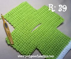 a crocheted square with a pair of scissors next to it