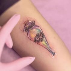 a small tattoo on the leg of a woman with a knife and skull in it