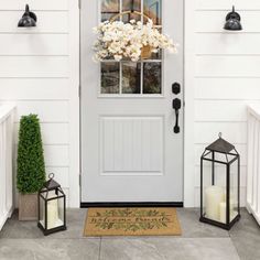 the front door is decorated with lanterns and flowers