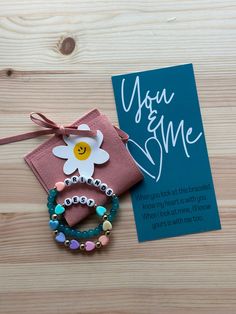 "Staying connected to your little bestie day after day. Whether a mommy, an aunt, or just a good friend - you & me bracelet set it a great reminder that your hearts are tied together!  The bracelets comes with the backing board (as pictured), the suede pouch, and the flower die cut.   The child bracelet will have all the heart colors and the adult bracelet will be whichever bead and heart color selected.  The large bracelet is an adult standard size of 6.75\" and the smaller bracelet is child st Personalized Friendship Bracelets For Birthday And Mother's Day, Multicolor Personalized Friendship Bracelets For Mother's Day, Multicolor Friendship Bracelets As Personalized Gifts For Mother's Day, Personalized Beaded Bracelets For Mother's Day Birthday Gift, Meaningful Bracelets For Birthday And Mother's Day, Adjustable Meaningful Name Bracelet For Best Friend, Inspirational Personalized Beaded Bracelets For Best Friend, Meaningful Adjustable Name Bracelet For Best Friend, Friendship Letter Bead Charm Bracelet For Valentine's Day