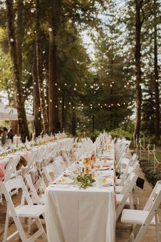 tables set up for an outdoor wedding reception in the woods