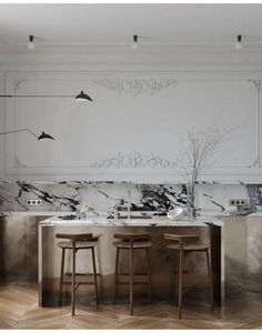 a kitchen with marble counter tops and stools in front of a wall painted with birds