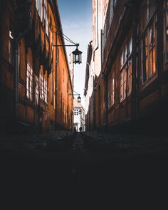 an alley way with buildings and street lights