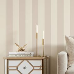 a living room scene with focus on the nightstand and striped wallpaper behind the couch