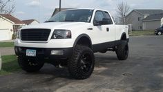 a white truck parked in a parking lot