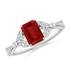 a red stone and diamond ring on a white background