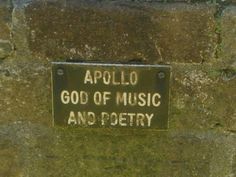 a sign that is on the side of a wall saying, apollo god of music and poetry