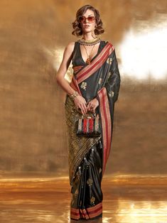 Elevate your reception attire with this stunning black zari weaving satin saree with blouse. The saree is crafted from high-quality satin material with intricate zari weaving work, adding a touch of elegance to your ensemble. The black color of the saree is versatile and can be paired with a variety of accessories for a traditional look.
The saree comes with a matching silk material blouse also adorned with zari weaving work, completing the set. The 5.50 meters of saree material allows for a com Black Silk Saree Look, Silk Saree Look, Black Silk Saree, Satin Sarees, Bridesmaid Saree, Handloom Weaving, Party Sarees, Black Pure, Ready To Wear Saree