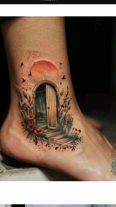 a woman's foot with an open door tattoo on it