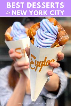 woman holding up two cones with blue frosting on them and the words best desserts in new york city