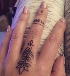 a woman's hand with a tattoo on it