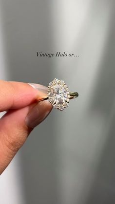 a woman's hand holding an engagement ring with the words vintage hub or on it