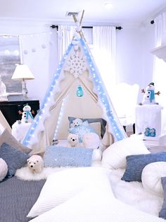 a bedroom decorated in blue and white with teddy bears