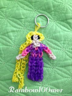 a crocheted keychain is shown on a green quilt