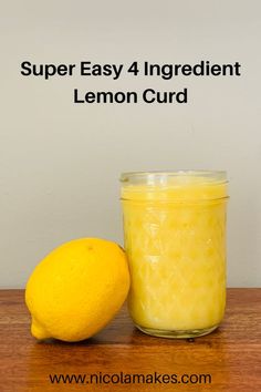 a lemon next to a jar of lemon curd