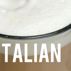 a glass filled with white liquid sitting on top of a table