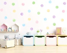 there are three bins in front of the wall with polka dot decals on it