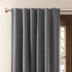 grey curtains hanging on the side of a door