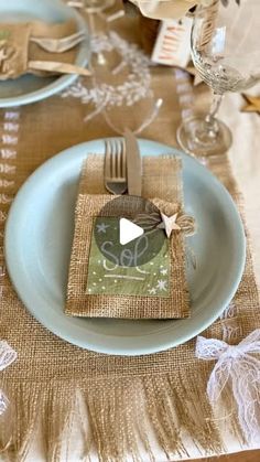 the place setting is ready to be served at this wedding reception, with burlap napkins and silverware