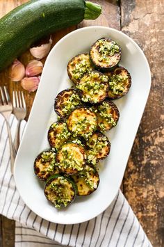 a white plate topped with grilled eggplant and pesto