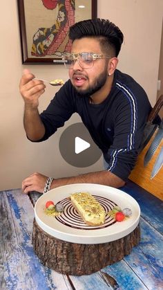 a man sitting at a table with a plate of food in front of his face