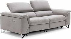 a grey reclining sofa sitting on top of a white floor