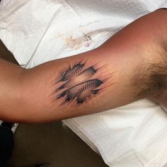 a man with a baseball tattoo on his arm