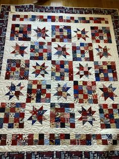 an old quilt with red, white and blue stars on it