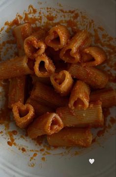 a white bowl filled with pasta covered in sauce