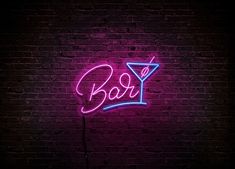 a neon sign that says boozy on a brick wall