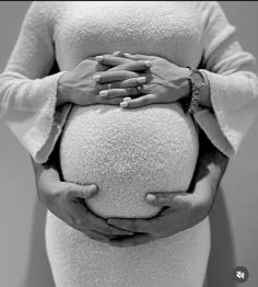 a pregnant woman with her hands on the belly