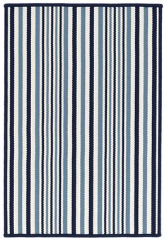 a blue and white rug with vertical stripes