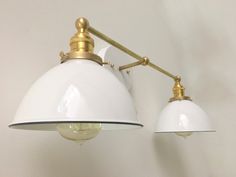 two white lamps are hanging on the wall