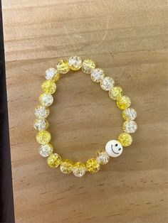 This is a larger sized bracelet, but can be made smaller for kids if needed. Glass beads are yellow and clear with a smiley bead included! Stretchy band. Yellow Beaded Bracelets With Round Beads For Everyday, Fun White Plastic Jewelry, Yellow Round Bead Bracelets For Everyday, Yellow Round Beads Bracelet For Everyday, Yellow Beaded Bracelets For Everyday, Everyday Yellow Stretch Bracelet With Round Beads, Yellow Adjustable Beaded Bracelets, Yellow Adjustable Beaded Bracelets Playful Style, Adjustable Yellow Playful Beaded Bracelets