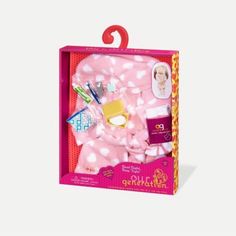 the doll is in its pink box with polka dot fabric and accessories on it's side