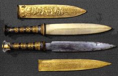 three different types of knifes with gold trimming and engraving on the handles, from front to back