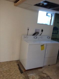 a white washer and dryer sitting inside of a room