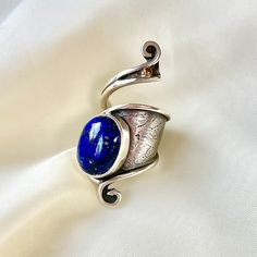 This 925 Sterling Silver adjustable wrap ring is purely handmade and natural Lapis Lazuli used. Crafted with meticulous attention to detail, our adjustable ring is designed to fit any finger, ensuring a perfect fit for everyone so it's an ideal gift option for yourself or your loved one!   Our Sterling Silver wrap ring, inspired by nature's wisdom, mirrors the transformative journey of the caterpillar within the cocoon, as it emerges into a beautiful butterfly. As you adorn yourself with this un Handmade Unique Sapphire Ring In Sterling Silver, Unique Sapphire Ring Stamped 925, Blue Hand Forged Rings As Gift, Unique Sapphire Ring In Sterling Silver With Open Shape, Hand Forged Sterling Silver Blue Ring, Silver Wrap Ring, Lapis Lazuli Ring, September Birthstone, Boho Ring