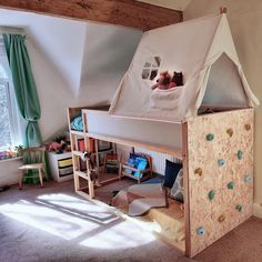 a child's bed with a tent on the top and shelves below it in a bedroom