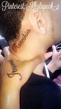 the back of a man's neck with his name tattooed on it