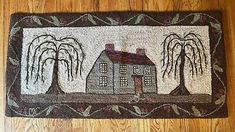 a door mat with a house and trees on it