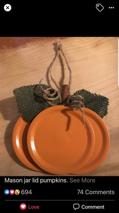 an orange plate sitting on top of a wooden table