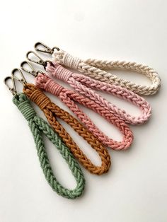 four different colored braided lanyards on white background