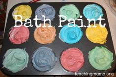 a tray filled with different colored cupcakes on top of a table