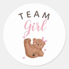 a round sticker with the words team girl and a bear on it's back